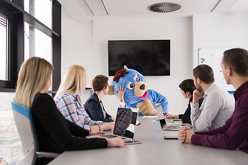 Image showing boss dresed as bear having fun with business people in trendy of