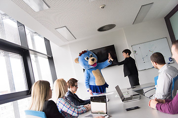 Image showing boss dresed as bear having fun with business people in trendy of