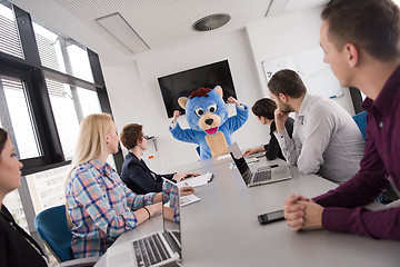 Image showing boss dresed as bear having fun with business people in trendy of