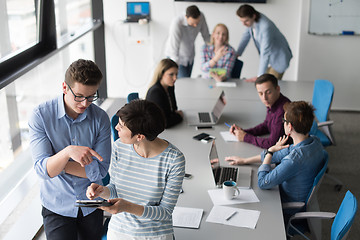 Image showing Two Business People Working With Tablet in office