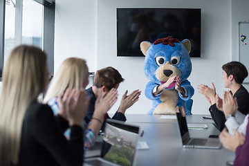 Image showing boss dresed as bear having fun with business people in trendy of