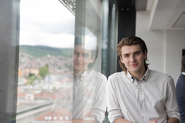 Image showing young businessman in startup office by the window