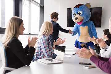 Image showing boss dresed as bear having fun with business people in trendy of