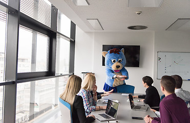 Image showing boss dresed as bear having fun with business people in trendy of