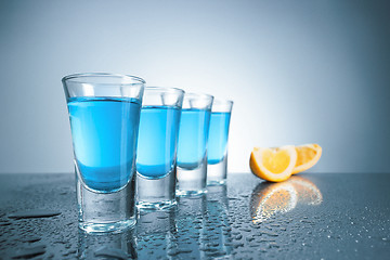 Image showing Vodka glass with ice on blue background