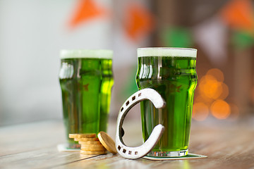 Image showing glass of green beer, horseshoe and gold coins