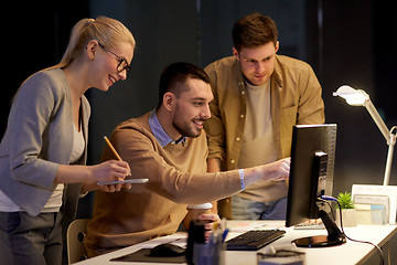 Image showing business team with computer working late at office