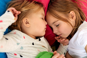 Image showing happy little girls sleeping in bed at home