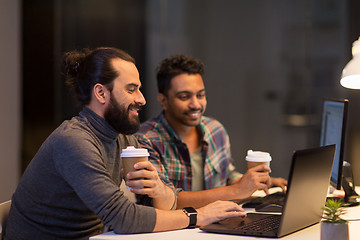 Image showing creative team drinking coffee at night office