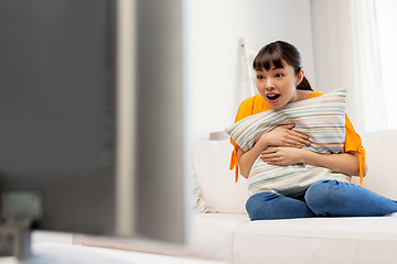 Image showing stunned asian woman with watching tv at home