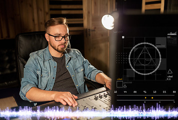 Image showing man at mixing console in music recording studio