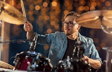 Image showing male musician playing drums and cymbals at concert