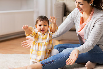 Image showing happy smiling mother with baby daughter at home