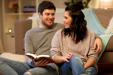 Image showing happy couple reading book at home