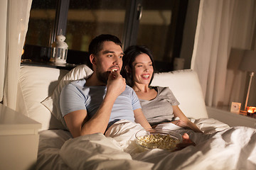 Image showing couple with popcorn watching tv at night at home