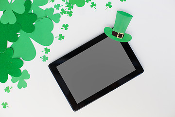 Image showing tablet pc and st patricks day decorations on white