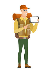 Image showing Smiling traveler holding tablet computer.