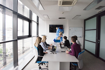 Image showing boss dresed as bear having fun with business people in trendy of