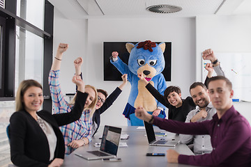 Image showing boss dresed as bear having fun with business people in trendy of