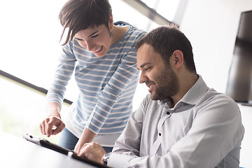 Image showing Two Business People Working With Tablet in startup office