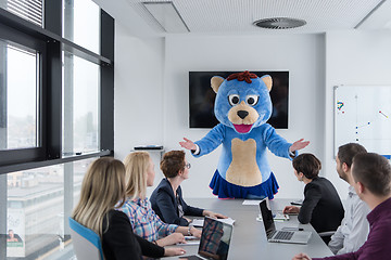 Image showing boss dresed as bear having fun with business people in trendy of