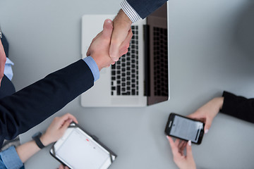 Image showing cloasing the deal in modern office interior top view