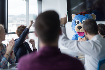 Image showing boss dresed as bear having fun with business people in trendy of