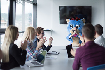 Image showing boss dresed as bear having fun with business people in trendy of