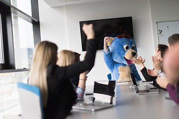 Image showing boss dresed as bear having fun with business people in trendy of