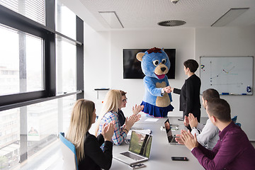 Image showing boss dresed as bear having fun with business people in trendy of