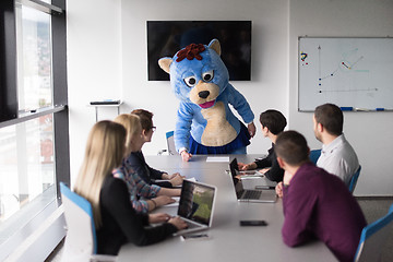 Image showing boss dresed as bear having fun with business people in trendy of