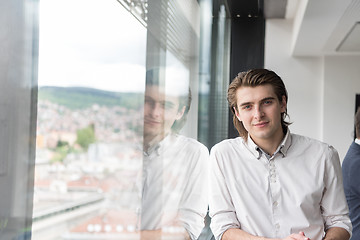 Image showing young businessman in startup office by the window