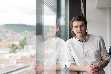 Image showing young businessman in startup office by the window
