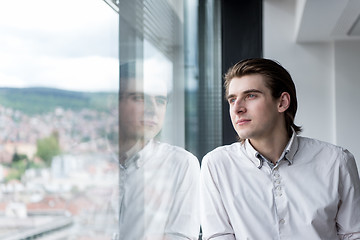 Image showing young businessman in startup office by the window