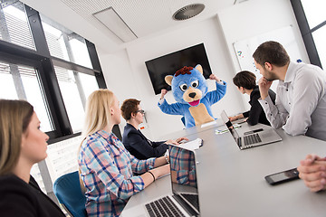 Image showing boss dresed as bear having fun with business people in trendy of