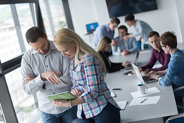 Image showing Two Business People Working With Tablet in office