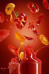 Image showing Red tomato with pait splash on red background