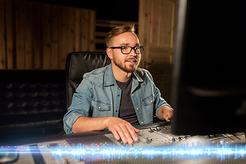 Image showing man at mixing console in music recording studio