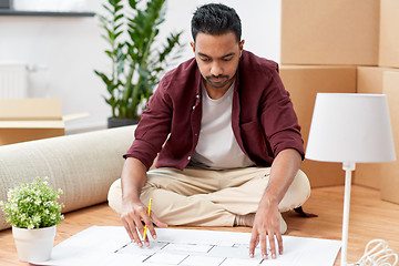 Image showing man with blueprint and boxes moving to new home