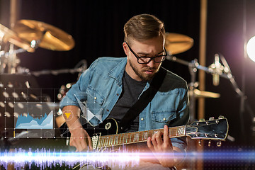 Image showing guitarist playing guitar at sound recording studio