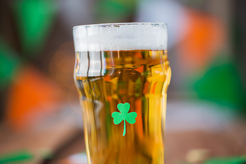 Image showing close up of glass of draft beer with shamrock