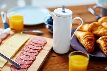 Image showing coffee pot and food on served table at breakfast