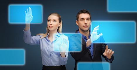 Image showing businessman and businesswoman with virtual screens