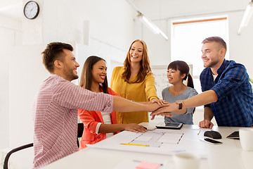 Image showing creative team holding hands together at office