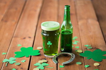 Image showing glass of green beer, horseshoe and gold coins