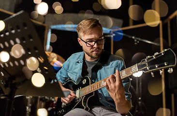 Image showing man playing guitar at studio rehearsal