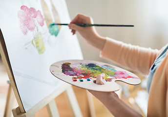 Image showing artist with palette painting at art studio