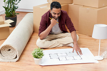 Image showing man with boxes and blueprint moving to new home