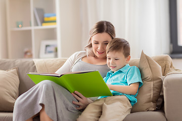 Image showing happy family reading book at home