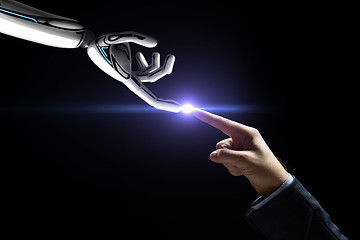 Image showing robot and human hand connecting fingers